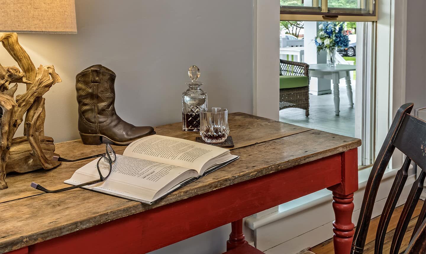 Rustic Desk with book, lamp, cowboy boot, and whiskey