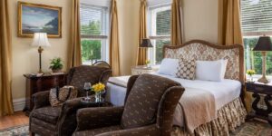 Bed and two chairs in Inglis Fletcher Suite