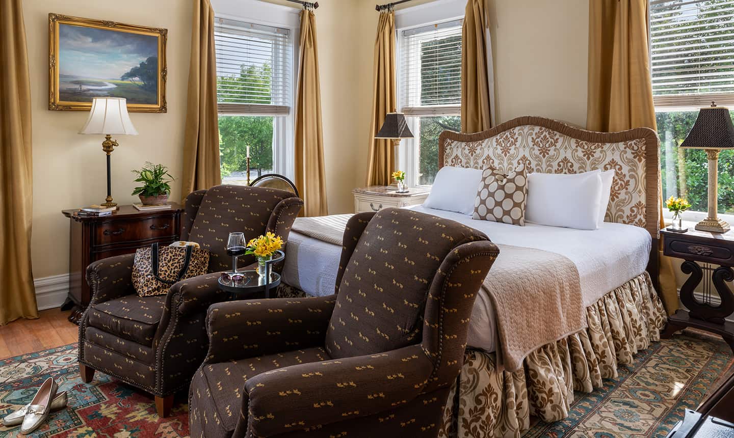Bed and two chairs in Inglis Fletcher Suite