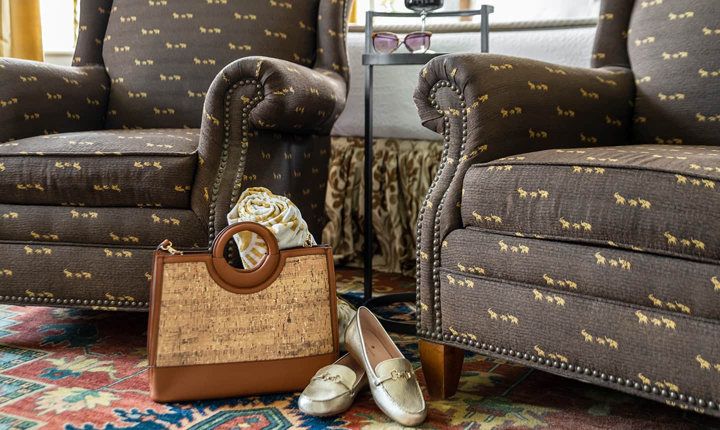 Closeup of two chairs with a bag and fancy shoes in Inglis Fletcher Room
