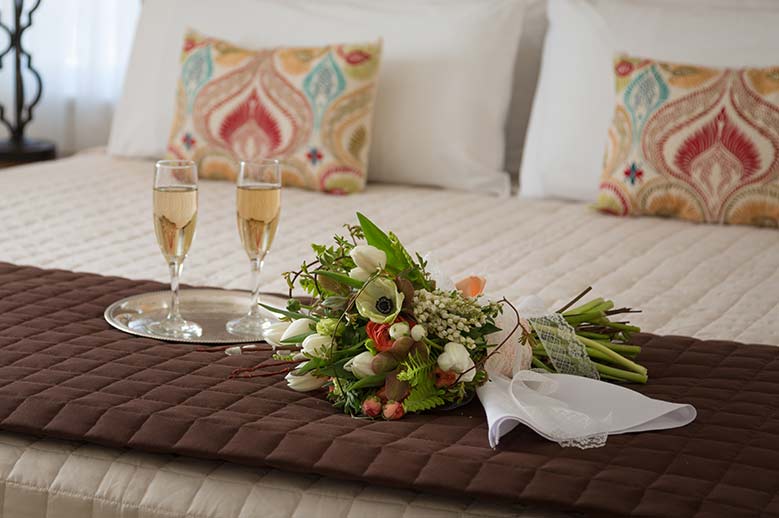 Customize your stay, bed, flowers sparkling wine.