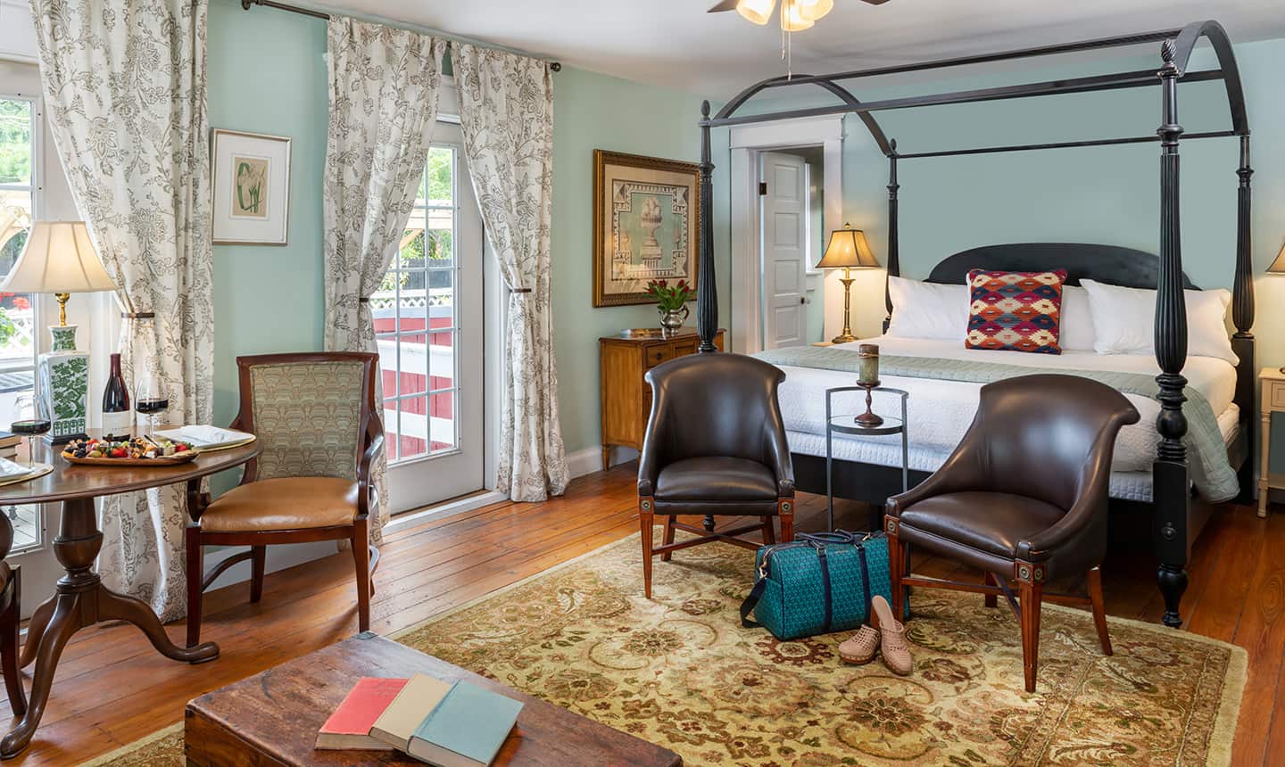 Canopy bed in Pembroke Suite with chairs and view to deck