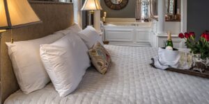 Bed with Tub in background of Satterfield Superior King Suite