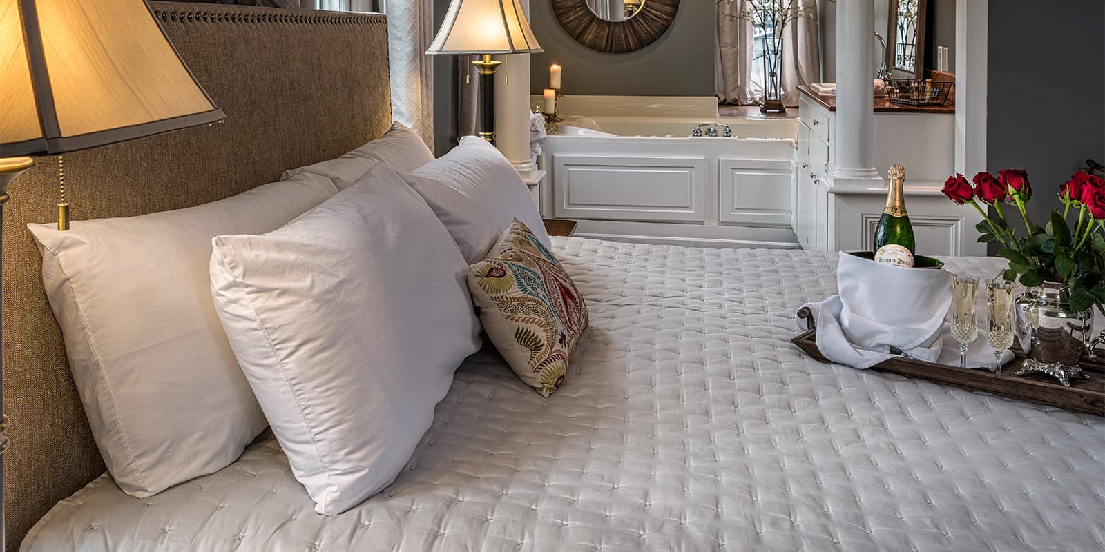 Bed with Tub in background of Satterfield Superior King Suite