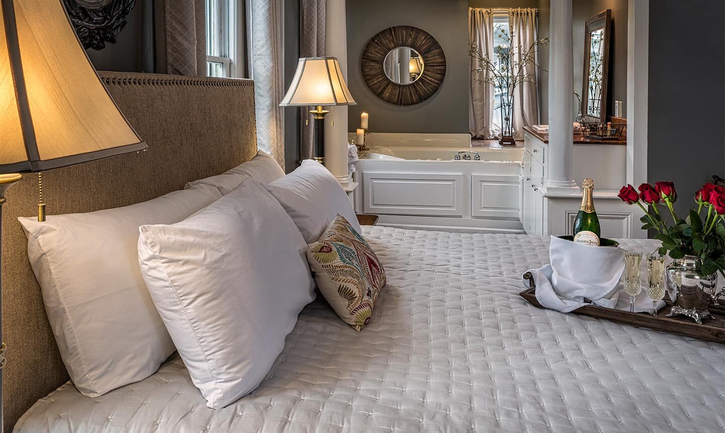 Bed with Tub in background of Satterfield Superior King Suite