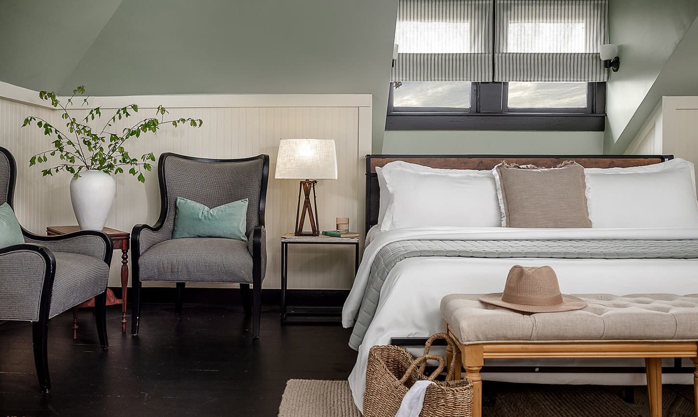 Bed, nightstand, and chairs in The Loft Suite