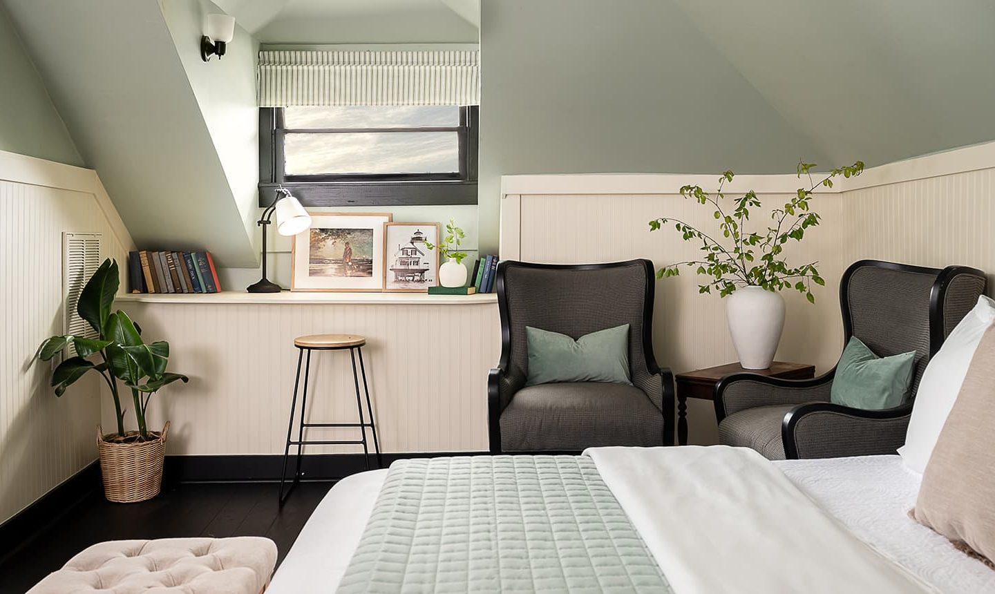 View of window with bookshelf and comfortable reading chairs in The Loft