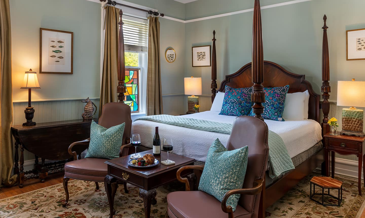 Four poster bed in Joseph Hewes Suite with two chairs
