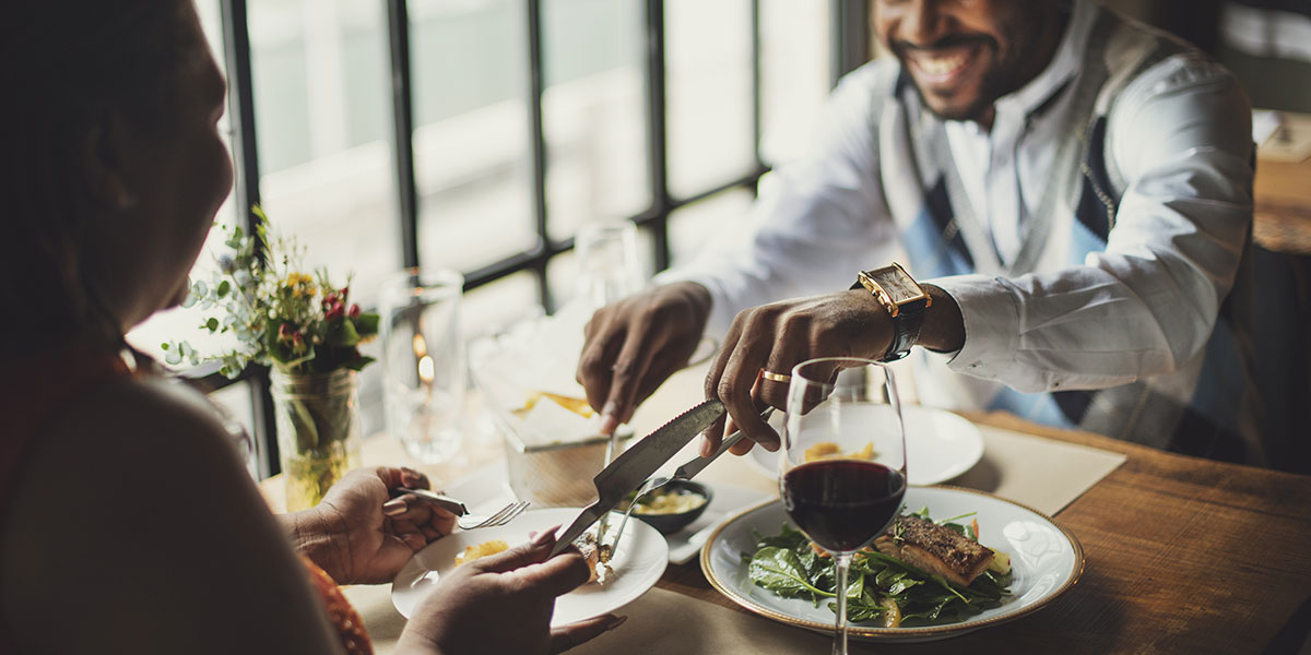 Couple dining sharing food.