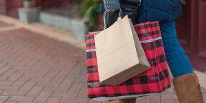 Woman walking with holiday shopping gifts