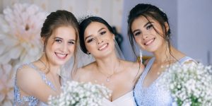 bride and bridesmaids smiling and holding bouquets