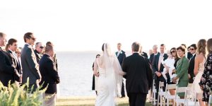 Bride and groom walking down the aisle in rfont of the water at Inner Banks Inn in North Carolina