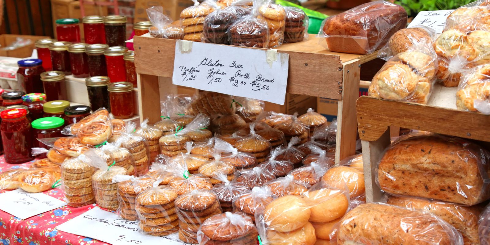 A table of fresh baked goods and homemade jams at a farmers market in North Carolina