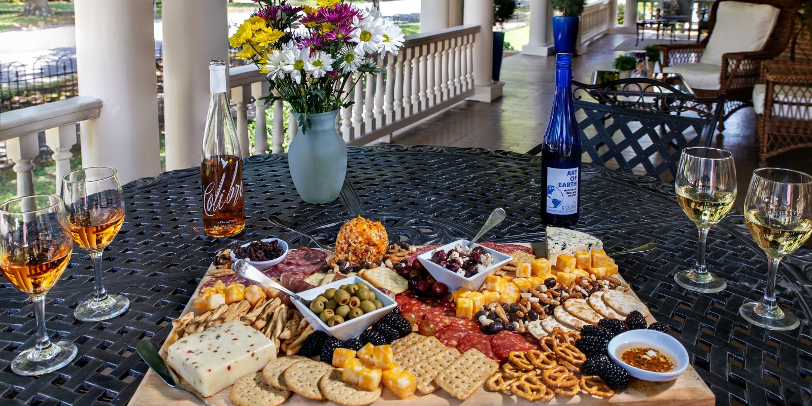 Charcuterie board and wine on the front porch of Inner Banks Inn