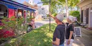 A retired couple in Edenton, North Carolina waving to the trolley