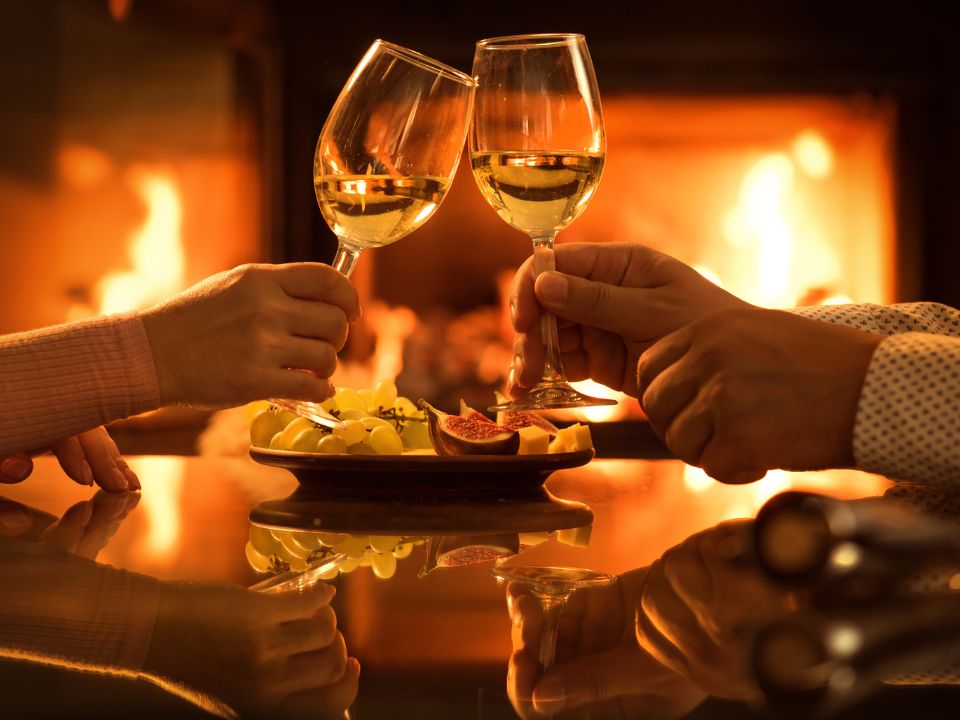 Toasting wine in front of fire